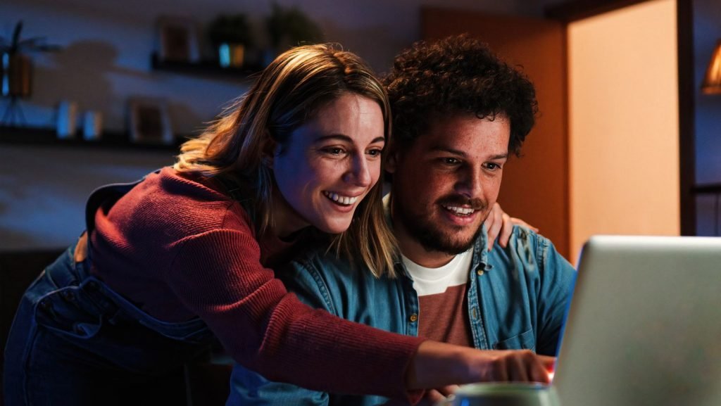 Young couple browsing the internet on a laptop.