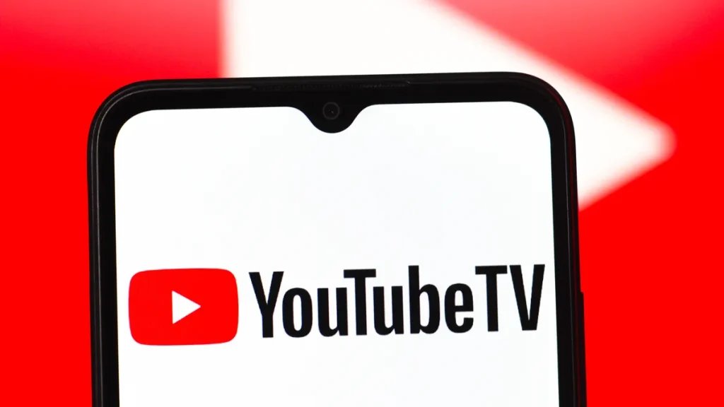 the YouTube TV logo on a mobile phone in front of a large red video play button in the background