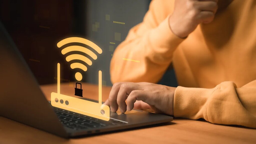 I Evaluate Routers for a Residing. Don’t Purchase a Router Proper Now Cybersecurity and WiFi protection concept. WiFi router with a lock symbol appears above a laptop, representing secure internet