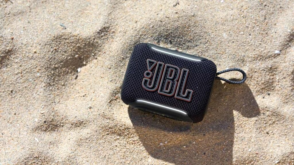 JBL simply upgraded two of our favourite Bluetooth audio system — one’s massive and highly effective, and one’s low-cost and transportable The JBL Go 5 on a beach.