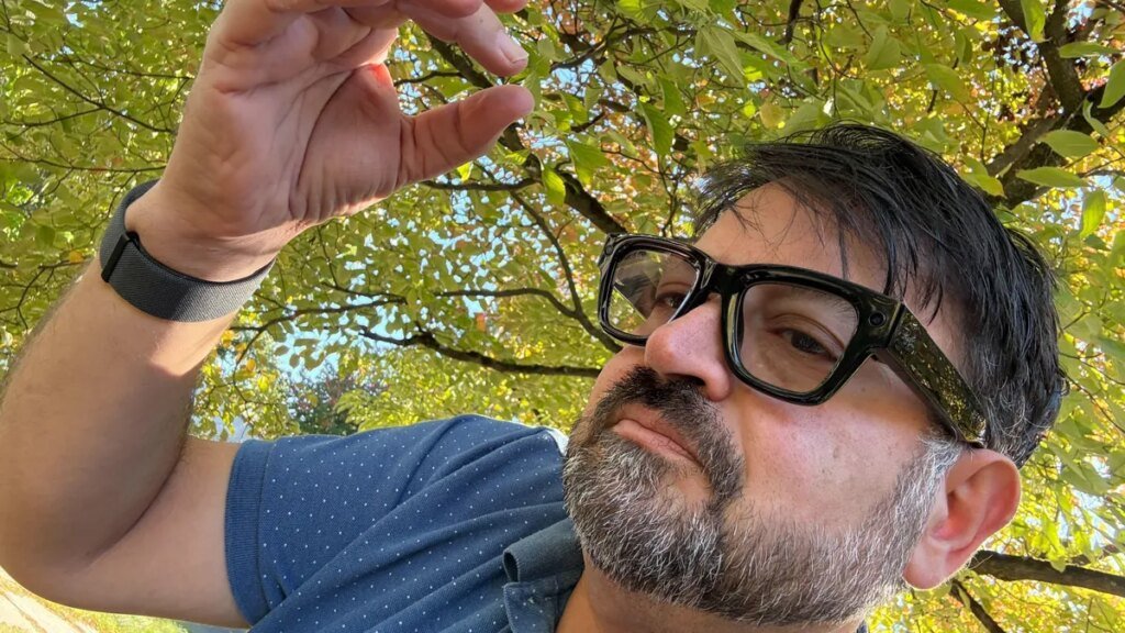 CNET's Scott Stein wearing the new Meta Ray-Ban Display smart glasses and neural wristband.