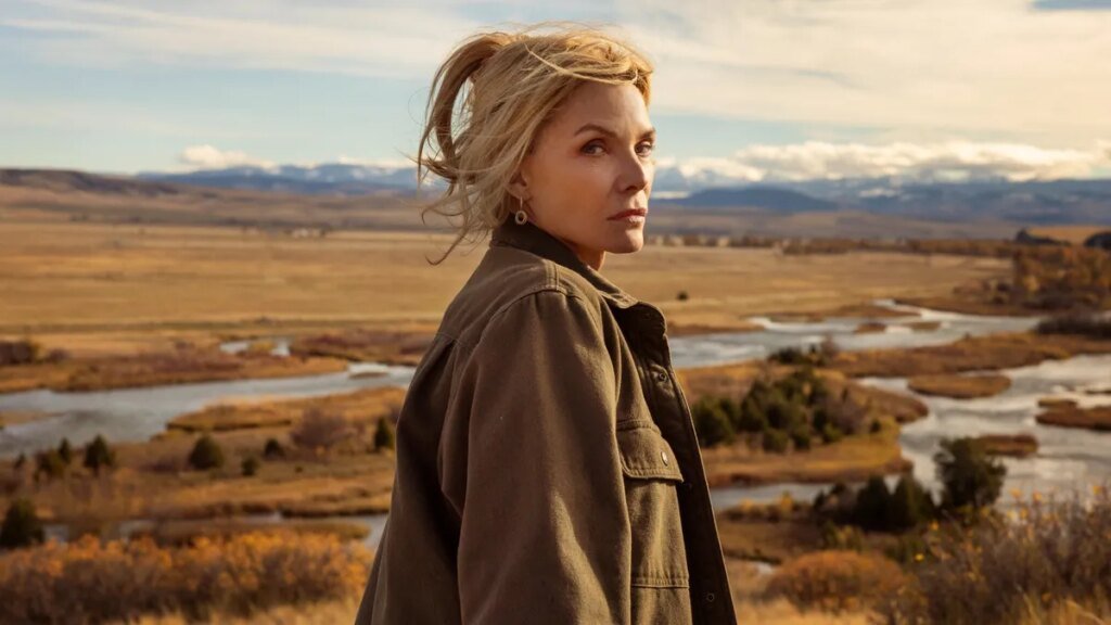 A production still from The Madison showing Michelle Pfeiffer standing in front of a beautiful countryside.