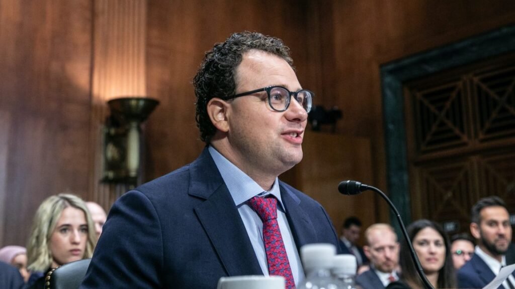 Trump moves to ban Anthropic from the US government Anthropic CEO Dario Amodei sitting at a table and speaking into a microphone during a Senate committee hearing.