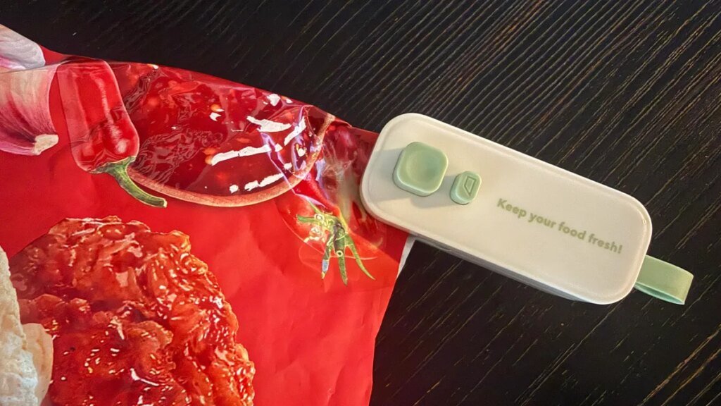 Are Electrical Bag Resealers the Key to Chip Freshness? I Examined 2 to Discover Out heated bag sealer being used on bag of chips