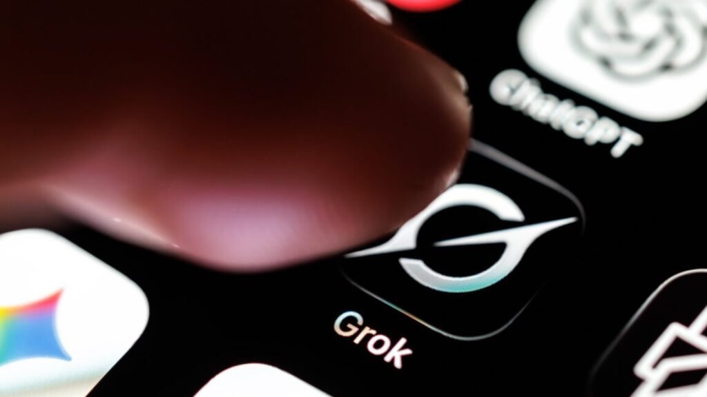 Elon Musk insists banks engaged on SpaceX IPO should purchase Grok subscriptions A person's finger hovering over the Grok app icon on a phone screen.
