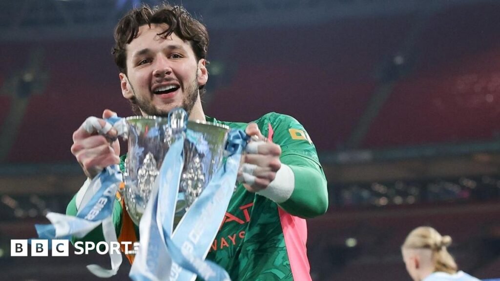 James Trafford holds the Carabao Cup trophy
