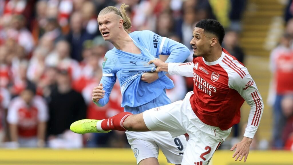 Erling Haaland battling with William Saliba in a recent Man City vs Arsenal game