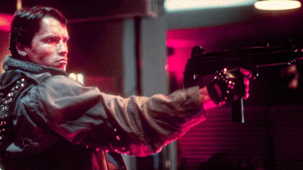 A still from The Terminator showing Arnold Schwarzenegger's terminator holding a gun