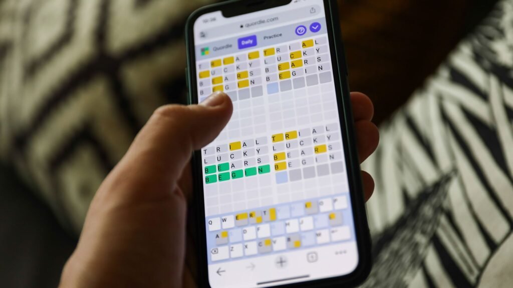 Quordle hints and solutions for Wednesday, April 15 (sport #1542) Quordle on a smartphone held in a hand