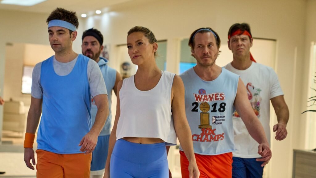 The main cast of Running Point strut down a hallway in gym gear