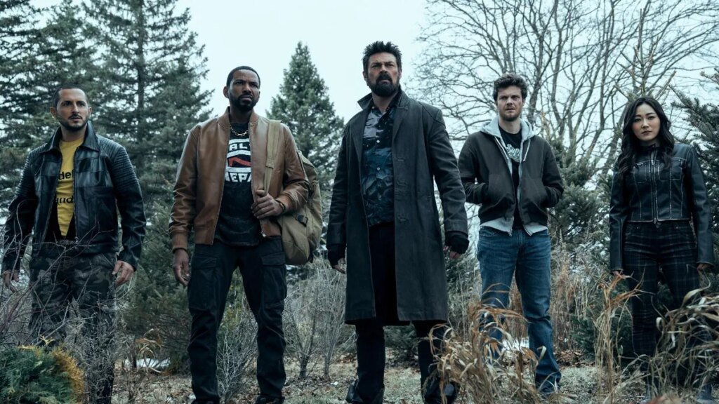 Production still from The Boys showing Karl Urban and crew standing looking concerned outside.