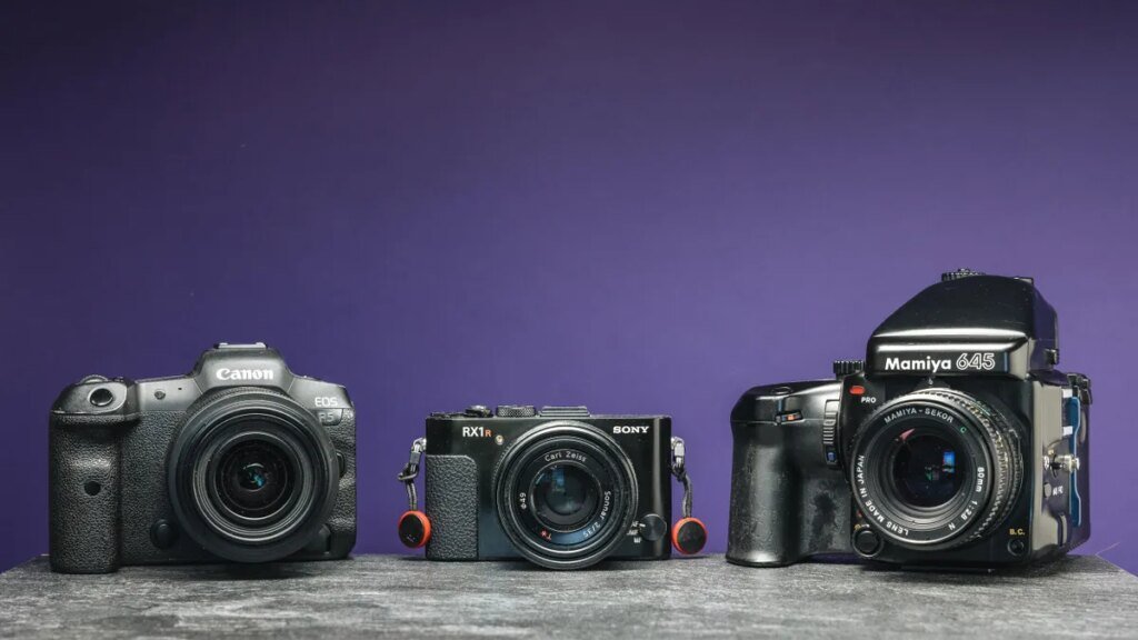 An image of three cameras with a purple background