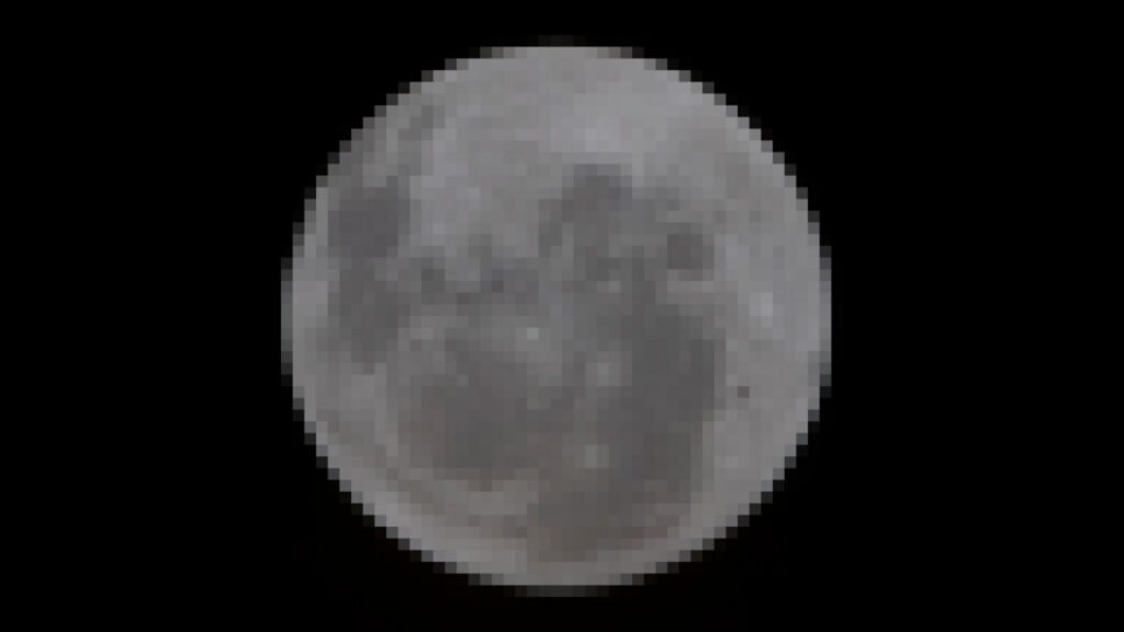 Video from Artemis II flyby of the Moon is not going to initially look spectacular A pixelated photo of a gray moon set against the blackness of space