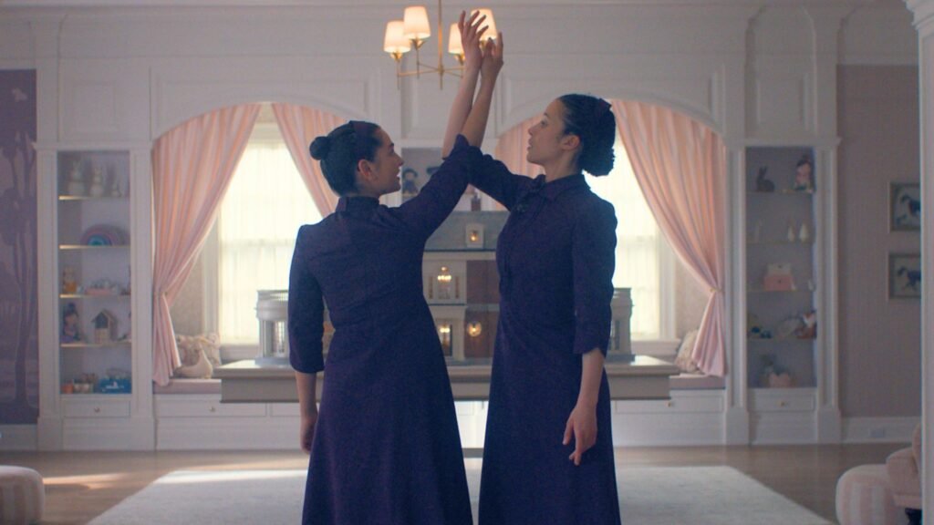 What’s the launch date for The Testaments episodes 1-3 on Hulu and Disney+? Two girls dressed in plum dance in the middle of a bedroom