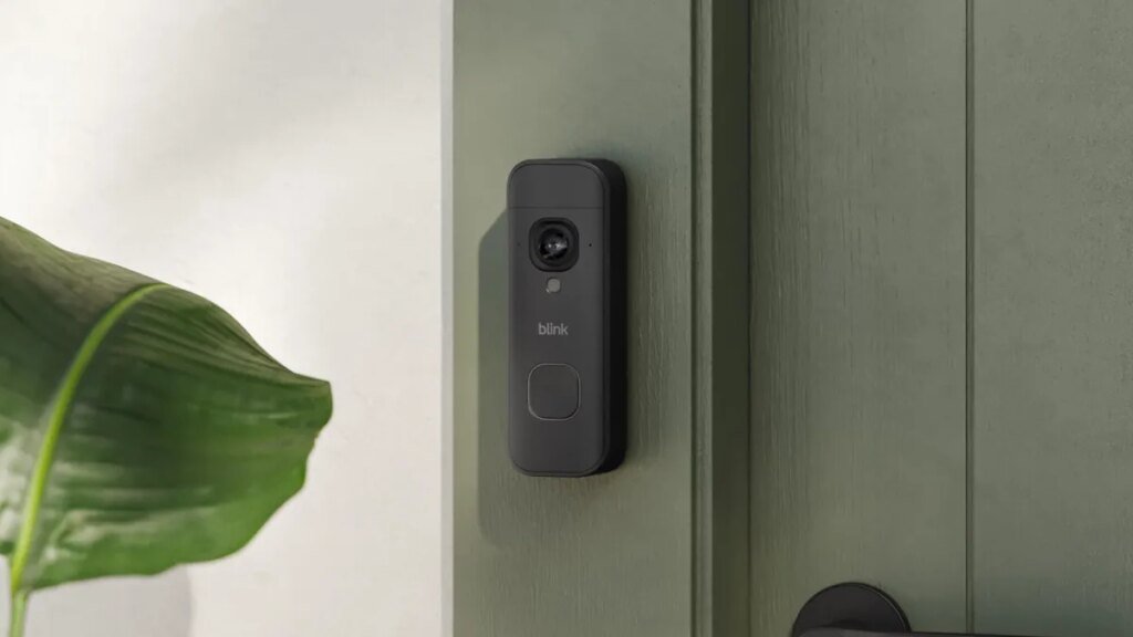 Blink's new battery doorbell on a gray door frame.
