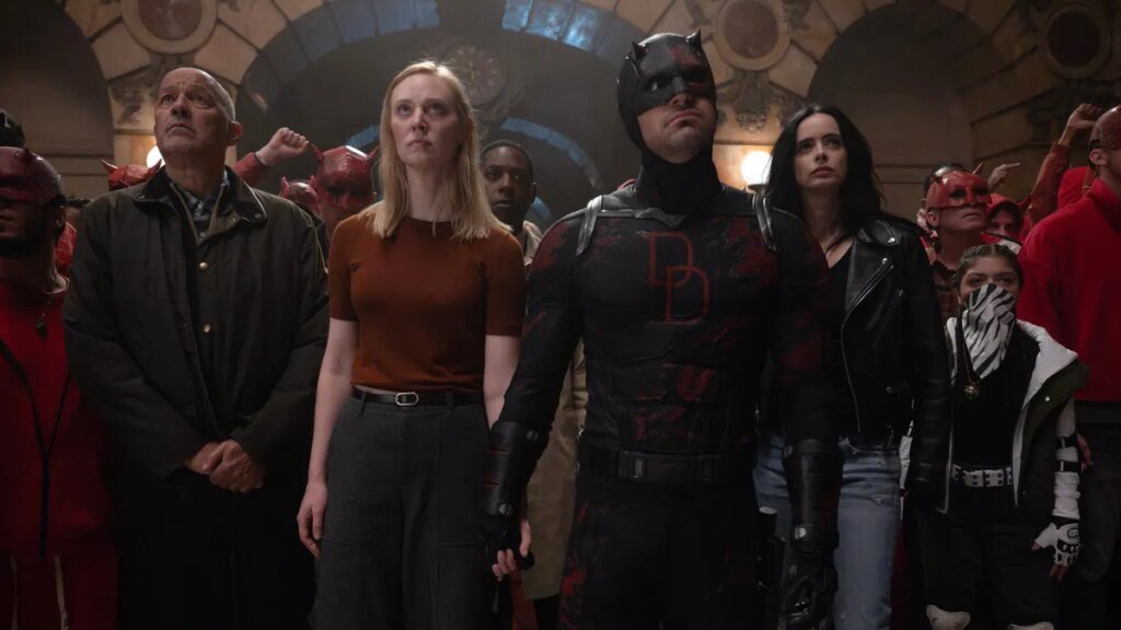 Cherry, Karen Page, Brett Mahoney, Matt Murdock/Daredevil, Jessica Jones and Angela Del Toro look upword at balcony in Daredevil Born Again.