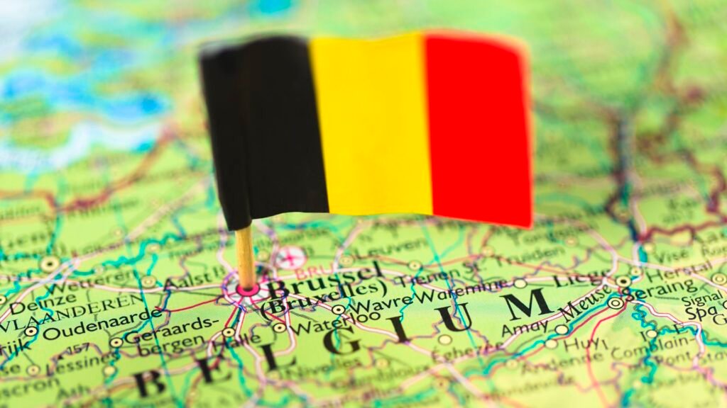 Close-up of a map of Belgium with a Belgian flag pinned at Brussels.