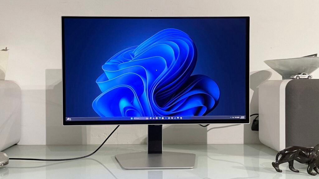 Samsung Odyssey OLED G6 G60SF monitor on a desk shown running Windows 11 desktop